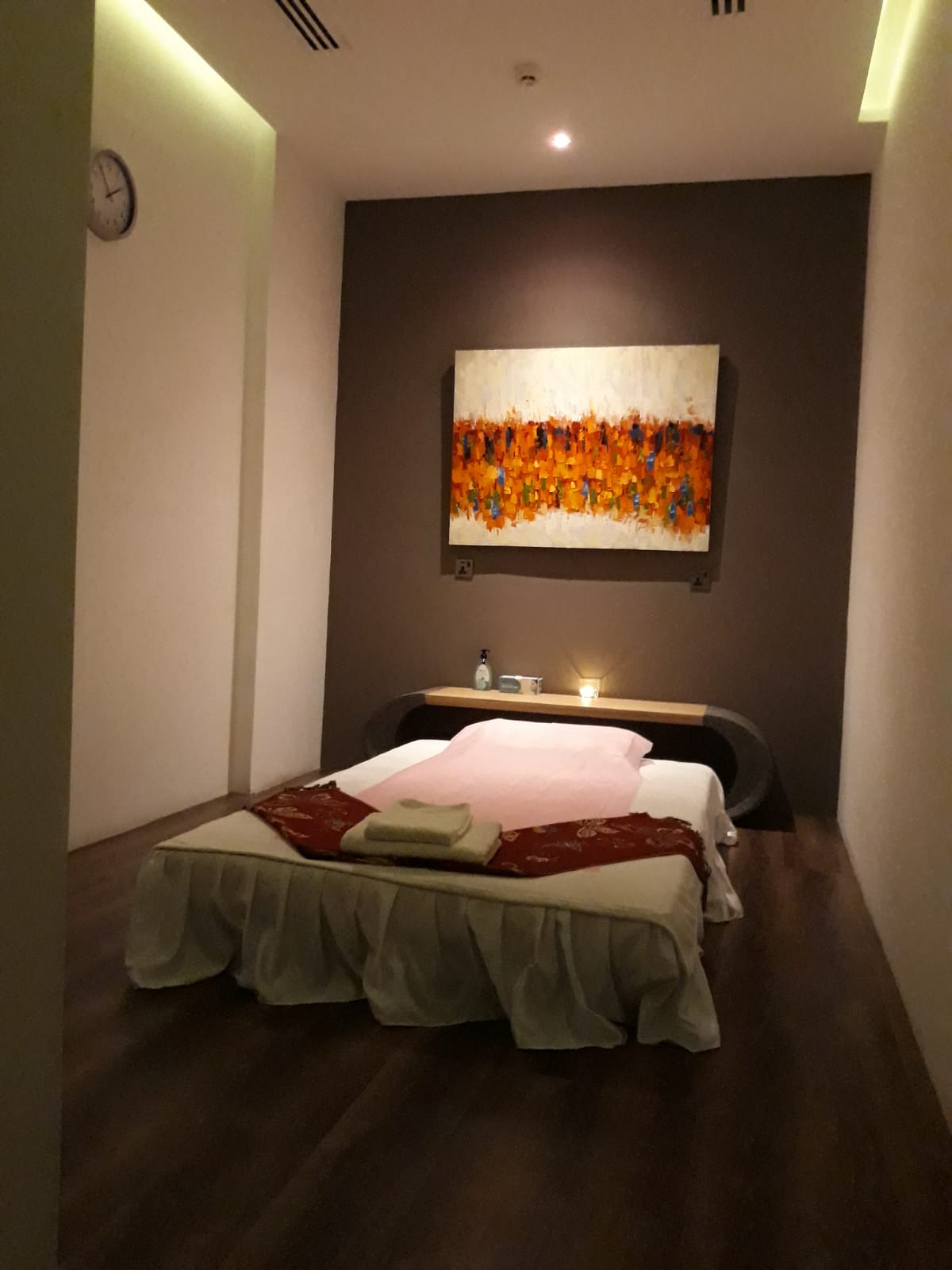 Photograph of massage therapy room with low massage bed